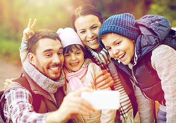 Image showing family taking selfie with smartphone in woods