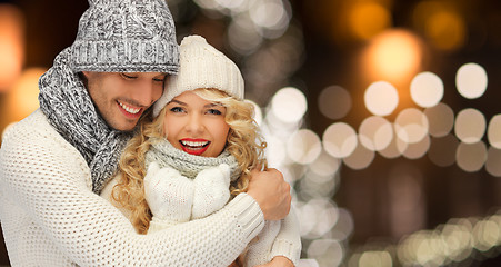 Image showing happy couple hugging over christmas lights