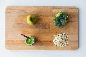 Image showing jar with puree or baby food on wooden board