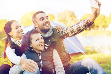 Image showing family with smartphone taking selfie at campsite