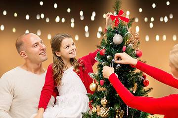 Image showing happy family decorating christmas tree at home