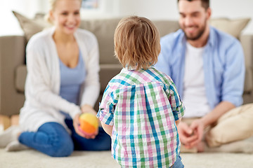 Image showing happy family playing with ball at home