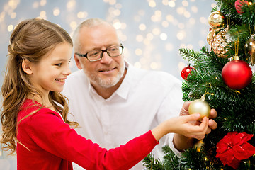 Image showing grandfather and granddaughter at christmas tree