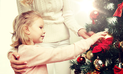 Image showing happy family decorating christmas tree at home