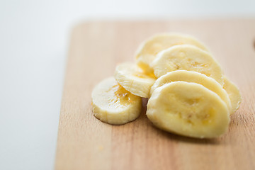 Image showing close up of banana on wooden cutting board