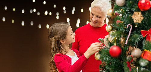 Image showing happy family decorating christmas tree