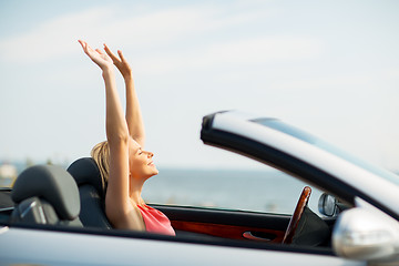 Image showing happy young woman in convertible car