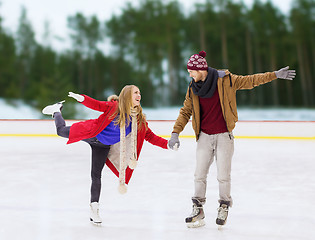 Image showing happy couple holding hands on skating rink