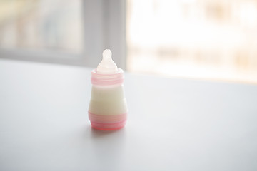 Image showing infant milk formula in baby bottle on table