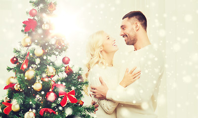 Image showing happy couple hugging near christmas tree at home