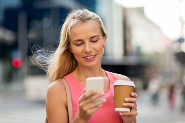 Image showing woman with coffee and smartphone in city