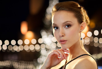 Image showing beautiful asian woman with earrings at christmas