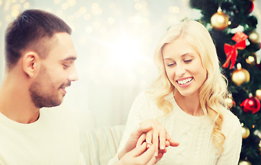 Image showing man giving woman engagement ring for christmas