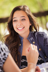 Image showing Expressive Young Adult Woman Having Drinks and Talking with Her 