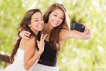 Image showing Two Attractive Mixed Race Girlfriends Using Their Smart Cell Pho