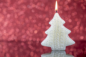 Image showing Christmas tree candle light with reflection on red blurred bokeh
