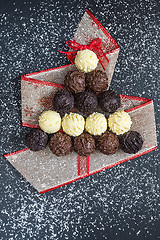 Image showing Chocolate pralines shape Christmas tree on black