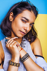 Image showing lifestyle people concept. young pretty smiling indian girl with long nails wearing lot of jewelry rings, asian summer happy cool