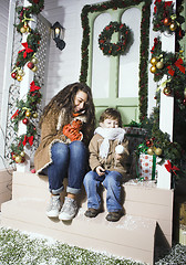 Image showing happy smiling family on Christmas at house with gifts, young mot