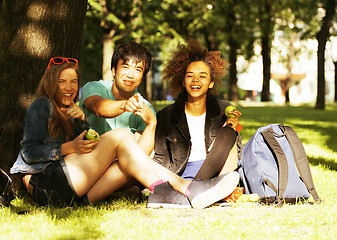 Image showing cute group of teenages at the building of university with books 