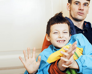 Image showing young handsome father with his son fooling around at home, lifes