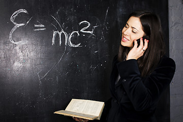 Image showing portrait of happy cute student in classroom at blackboard back t