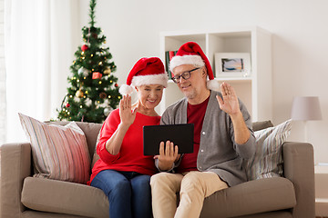 Image showing happy senior couple with tablet pc at christmas