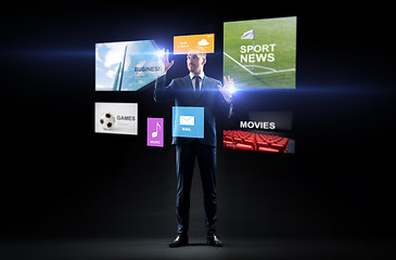 Image showing businessman with applications on virtual screen