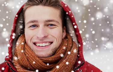 Image showing close up of happy man in winter jacket with hood