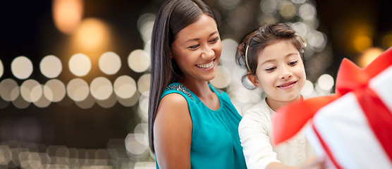 Image showing happy mother and daughter with christmas gift