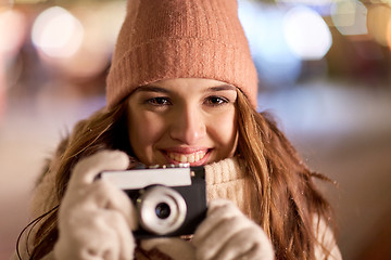 Image showing close up of young woman with camera at christmas