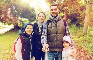 Image showing family with backpacks taking selfie and hiking