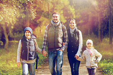 Image showing happy family with backpacks hiking