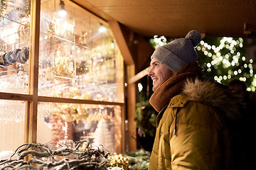 Image showing happy man looking at christmas market shop window