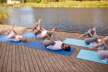 Image showing group of people making yoga exercises outdoors