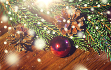 Image showing fir branch with christmas ball and pinecones