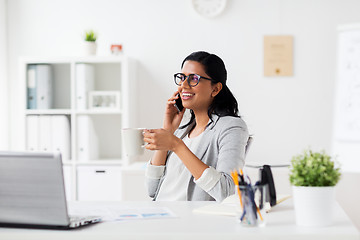 Image showing businesswoman calling on smartphone at office