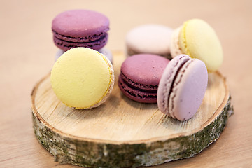 Image showing different macarons on wooden stand