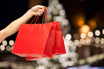 Image showing close up of hand with shopping bags at christmas