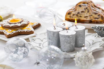 Image showing Decorated Christmas table with gingerbread candle