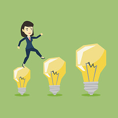 Image showing Business woman jumping on light bulbs.