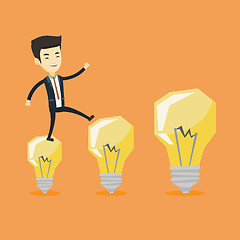 Image showing Business man jumping on light bulbs.