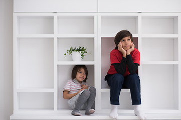 Image showing young boys posing on a shelf