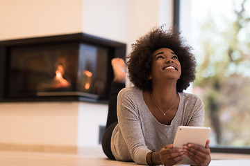 Image showing black women using tablet computer on the floor