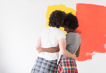 Image showing multiethnic couple painting interior wall