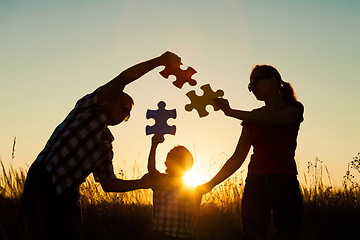 Image showing Happy family playing at the park at the sunset time.