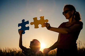 Image showing Mother and son playing at the park at the sunset time.