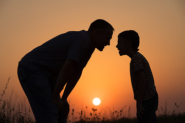 Image showing Father and son playing in the park at the sunset time. 