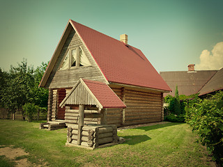 Image showing wooden house and well in the yard