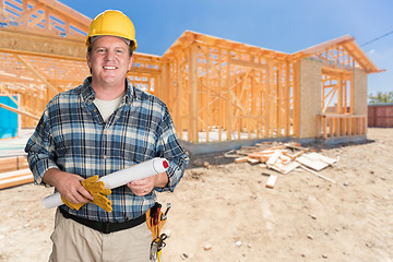 Image showing Male Contractor With House Plans Wearing Hard Hat In Front of Ne